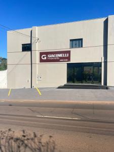 a building with a sign on the side of it at Giacomelli Plaza Hotel in Rio Verde