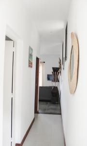 a hallway leading to a living room with white walls at Résidence Marotia in Antananarivo +49 photos