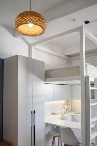 a room with a bunk bed and a table and chairs at Skala Hostel in Almaty