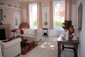 a living room with a couch and a table at Collins House in Knaresborough