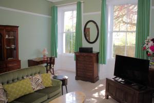 a living room with a couch and a television at Collins House in Knaresborough