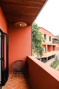 a chair sitting on a balcony with an orange wall at Résidence Marotia in Antananarivo