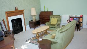 a living room with a couch and a table and chairs at Collins House in Knaresborough