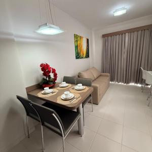 a living room with a table and a couch at Veredas Do Rio Quente Flat Service 723 in Rio Quente