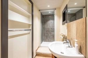 a bathroom with a sink and a shower at Le charron in Bièvre +27 photos