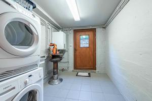 a laundry room with a washer and dryer at Le charron in Bièvre