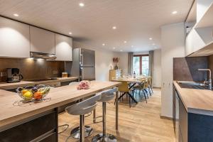 a kitchen with a large island with bar stools at Le charron in Bièvre