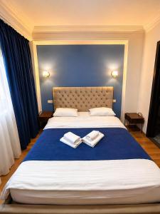 a bedroom with a large bed with two towels on it at BB Old City in Tbilisi City