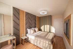a hotel room with a bed and a television at Harmony Suites - Dream Island in Sunny Beach +45 photos