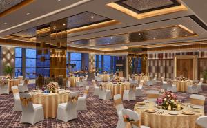 a ballroom with tables and chairs in a room with windows at Hyatt Place Bhopal in Bhopal +31 photos