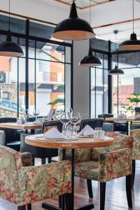 a restaurant with tables and chairs and windows at Grand Hotel Urban in Antananarivo