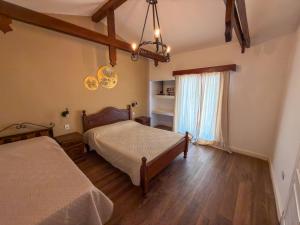 a bedroom with two beds and a window at Hueso cue 105 in Paso de la Patria