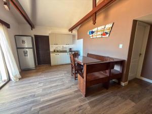 a kitchen with a dining table and a refrigerator at Hueso cue 105 in Paso de la Patria