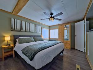 a bedroom with a bed and a ceiling fan at Hillcrest Hideaway Spacious Mountain View Oasis in Hillcrest Mines