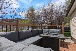 a couch sitting on a deck with a table at Hillcrest Hideaway Spacious Mountain View Oasis in Hillcrest Mines