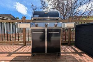 a barbecue with a grill on top of a fence at Hillcrest Hideaway Spacious Mountain View Oasis in Hillcrest Mines