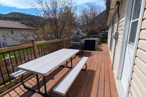 a wooden deck with a picnic bench on a house at Hillcrest Hideaway Spacious Mountain View Oasis in Hillcrest Mines