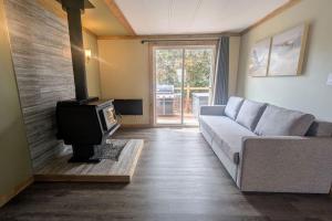 a living room with a couch and a tv at Hillcrest Hideaway Spacious Mountain View Oasis in Hillcrest Mines +21 photos