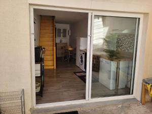 a sliding glass door leading into a kitchen with a counter at Gite Comme a la maison in Damery +9 photos