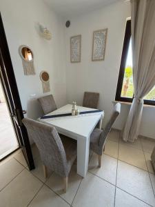 a dining room with a white table and chairs at Casa Jeyel in Lazise