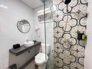 a bathroom with a toilet and a sink and a shower at Front One The Andia Boyolali in Boyolali +21 photos