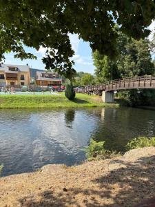 a bridge over a river in a park at Casa Rural Picón con jardín y piscina privada in Ocero