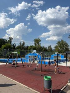 a child playing on a swing set at a playground at Casa Rural Picón con jardín y piscina privada in Ocero