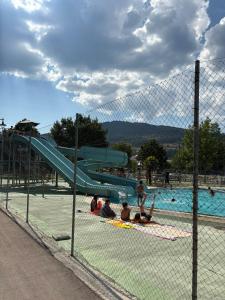 a group of people laying in front of a swimming pool at Casa Rural Picón con jardín y piscina privada in Ocero