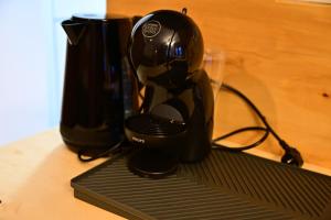 a black coffee maker sitting on top of a table at FLH - Hömvert in Sibiu