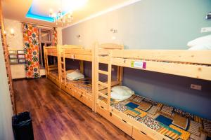 two bunk beds in a room with wooden floors at Greg&Tom Beer House Hostel in Krakow