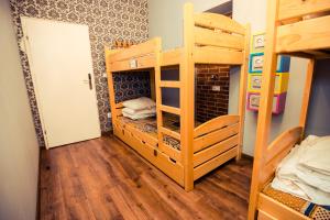 a room with two bunk beds and a door at Greg&Tom Beer House Hostel in Krakow