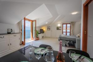 a dining room and living room with a view of the ocean at Marble House Varenna Lake Como in Varenna