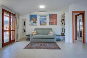 a living room with a couch and a rug at Marble House Varenna Lake Como in Varenna +39 photos