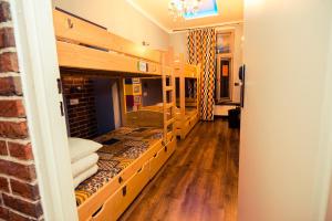 a room with two bunk beds with wood floors at Greg&Tom Beer House Hostel in Krakow