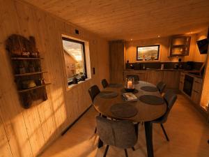 a dining room with a table and chairs in a room at Chalet Glåpen in Moskenes