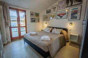 a bedroom with a bed with two towels on it at Marble House Varenna Lake Como in Varenna