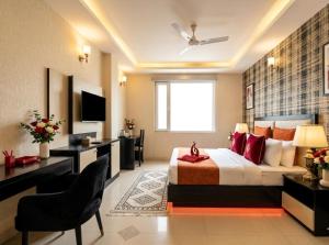a hotel room with a bed and a desk at Hotel Sky Nest Suites Near IGI Airport Delhi in New Delhi