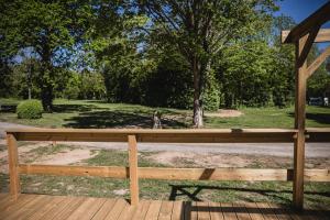 a wooden bench sitting on top of a wooden deck at Camping Terre d'Armor in Bourseul +6 photos