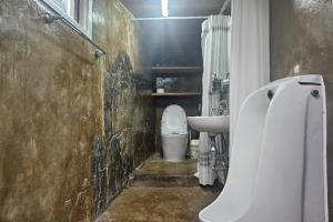 a bathroom with a white toilet and a sink at Guma Modern HanokStay in Daegu +43 photos