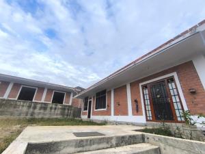 a brick building with a door in front of it at JJ Guest House Kuelap in Nuevo Tingo