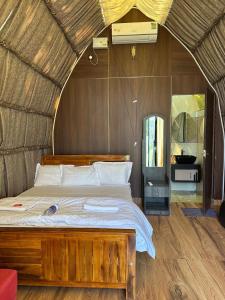 a bedroom with a large bed in a room at Riva farmstay in Mayyanād