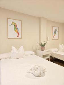 a hotel room with a bed with a towel on it at Hotel Celta in Vigo