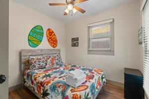 a bedroom with a bed and a ceiling fan at Sandy Turtle-Gone to the Beach Be Back Never in Galveston