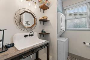 a bathroom with a sink and a mirror at Sandy Turtle-Gone to the Beach Be Back Never in Galveston +20 photos