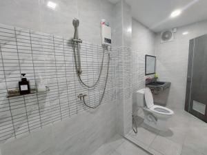 a bathroom with a shower and a toilet at Lynn Living (ลินน์ ลิฟวิ่ง) in Ban Non Muang +3 photos