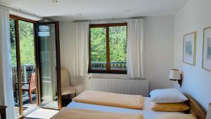 a bedroom with a bed and a window at Hupfmühle Pension in St. Wolfgang