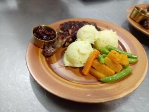 a plate of food with vegetables and mashed potatoes at Padiwatte Residencies in Kandy
