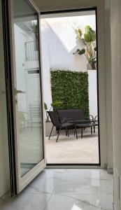 a sliding glass door leading to a patio with a bench at Ippolita Palace LUXURY ROOMS in Otranto
