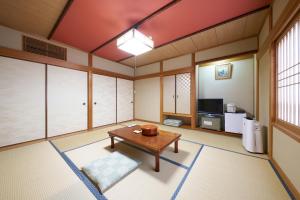 a living room with a table and a tv at Yodoya in Toyooka