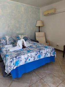 a bedroom with a bed with a stuffed animal on it at Indigo Moon in Quartu SantʼElena